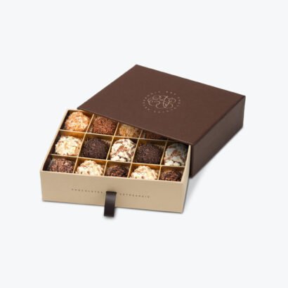 Chocolate boxes with a sleek brown lid and neatly arranged truffles, showcasing elegance and quality packaging.