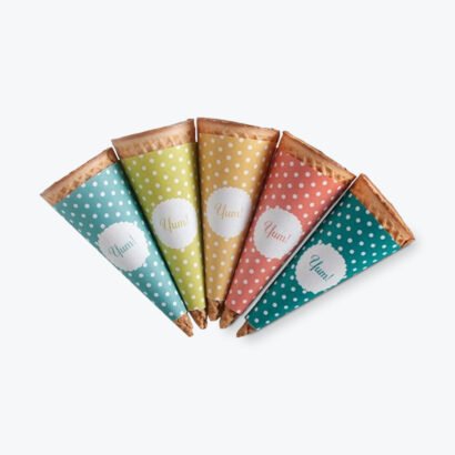 Colorful custom cone sleeves with polka dot designs and "Yum!" branding on waffle cones.