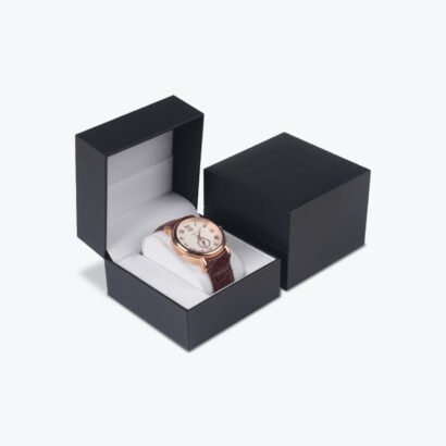Black luxury watch box with a sleek design, featuring a classic rose gold watch with a leather strap inside.