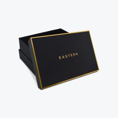 Luxury apparel box with gold foil accents and a sleek black matte finish.