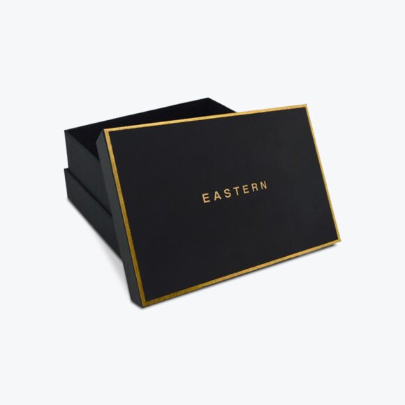 Luxury apparel box with gold foil accents and a sleek black matte finish.