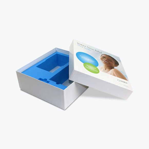 Custom pill packaging featuring a white box with a blue foam insert for secure product placement.