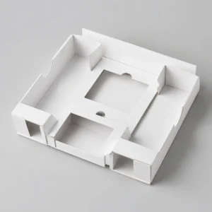 Paperboard insert trays with folded compartments and die-cut spaces for secure product placement